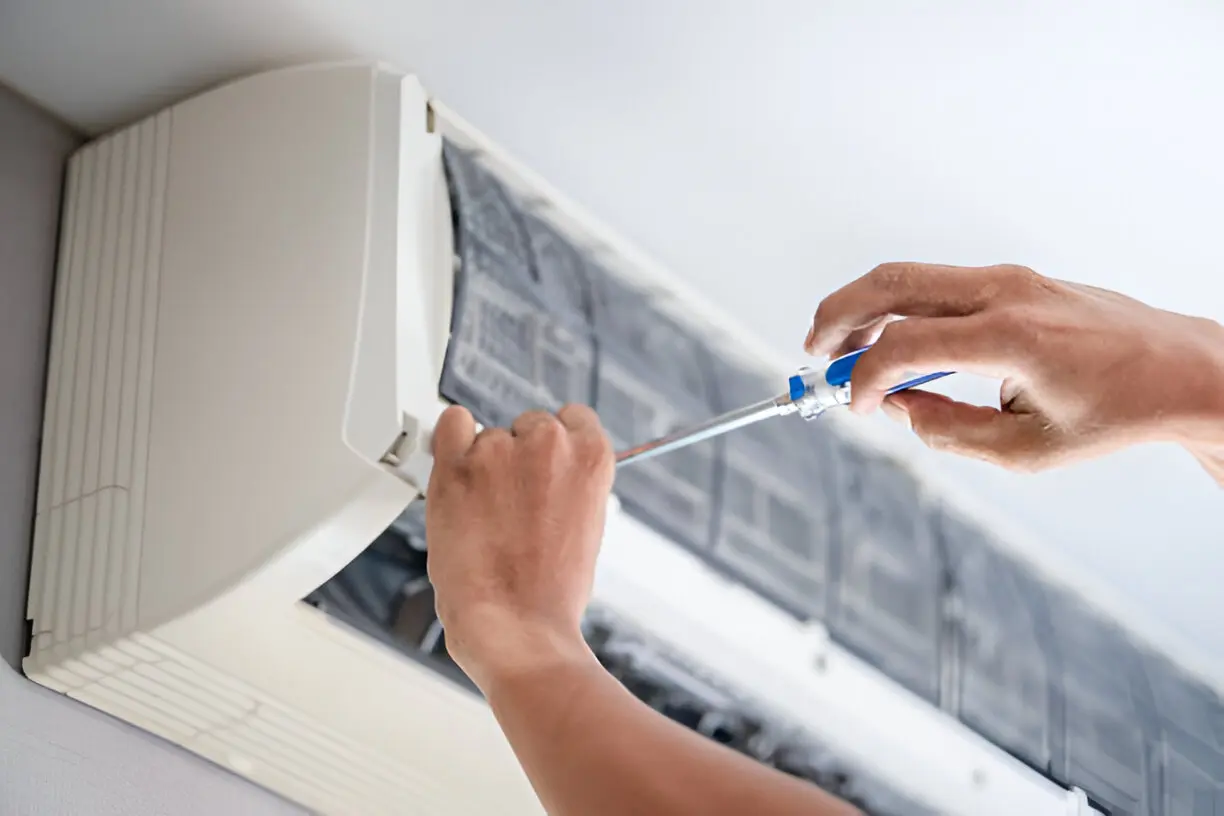 Home 12 Skilled technician repairing residential air conditioner in Tampa.